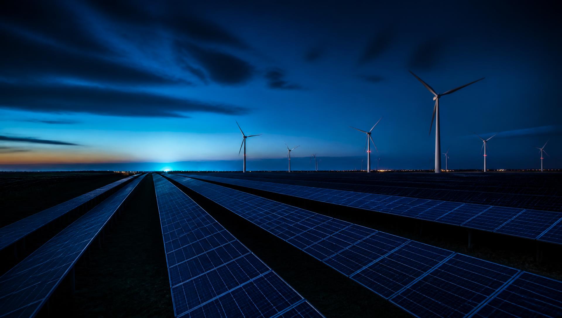 Solar photovoltaic farm and wind turbines at blue hour