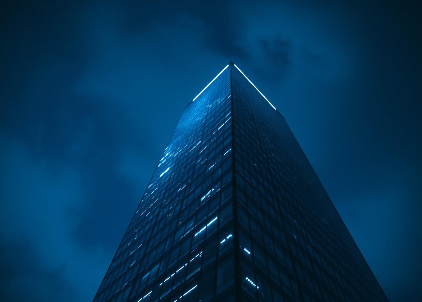 Commercial glass office tower at blue hour